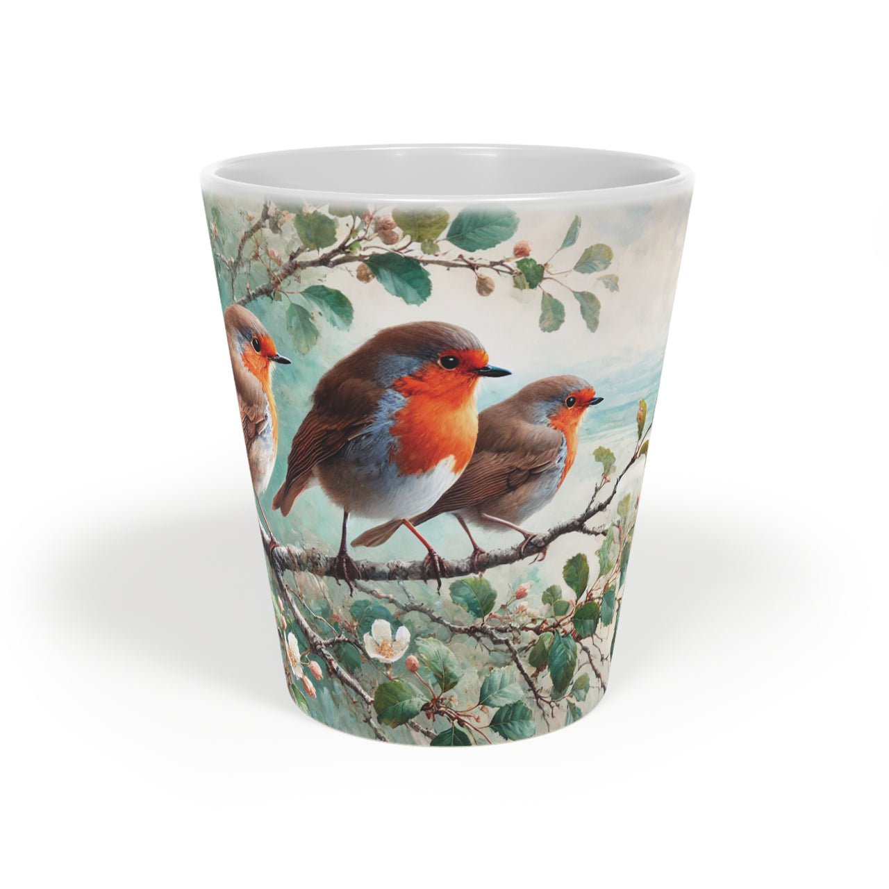 Ceramic mug featuring an illustration of three red robin birds perched on a branch surrounded by foliage, designed for bird lovers and nature enthusiasts, with a detailed, nature-inspired artwork.