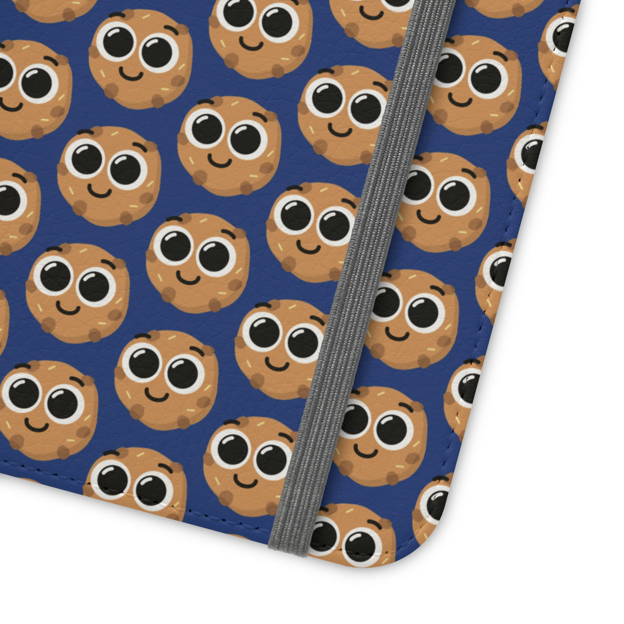 Close-up of the ChocoChip Delight Flip Phone Case featuring a cute repeating pattern of cartoon-style cookies with large eyes on a blue background, crafted from premium faux vegan leather, with interior card slots and an elastic closure.